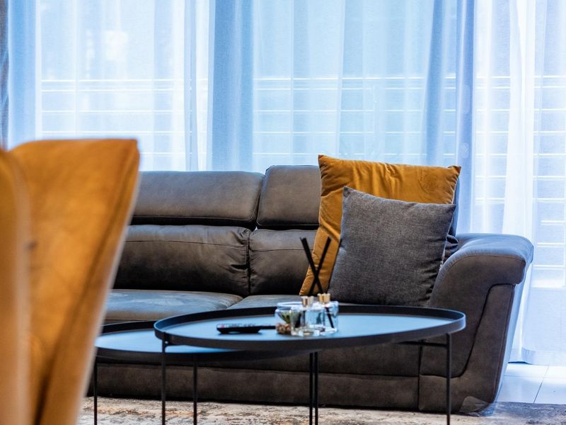 A comfortable living area featuring large glass sliding doors that allow for ample natural light and access to the outdoor space.
