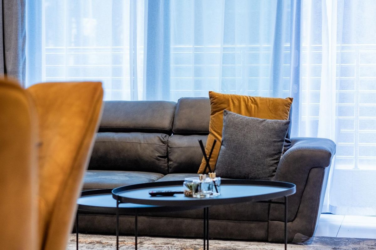 A comfortable living area featuring large glass sliding doors that allow for ample natural light and access to the outdoor space.