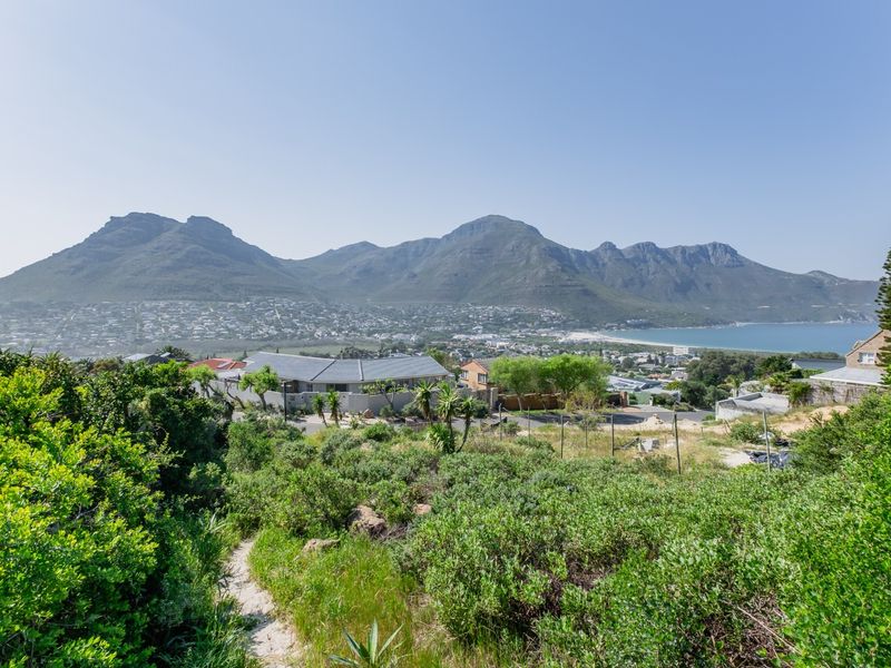 Elevated view overlooking the coastal town, surrounding mountains, and ocean bay from the residential plot.