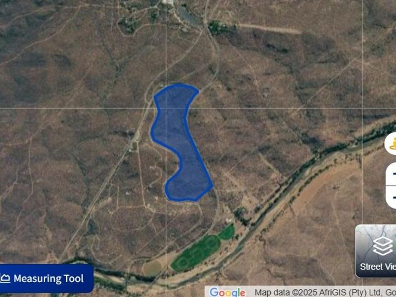 An aerial satellite view showing the boundaries of the vacant residential land plot within the surrounding landscape.