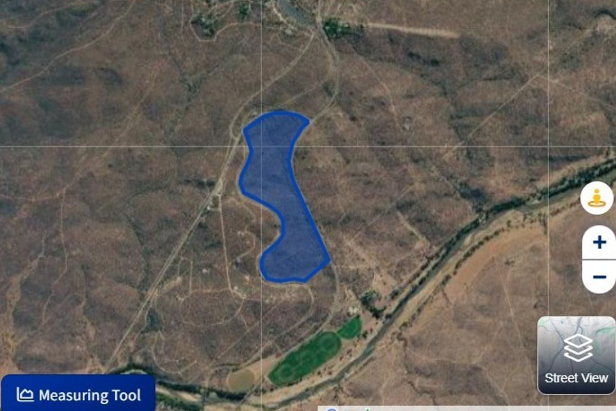 An aerial satellite view showing the boundaries of the vacant residential land plot within the surrounding landscape.