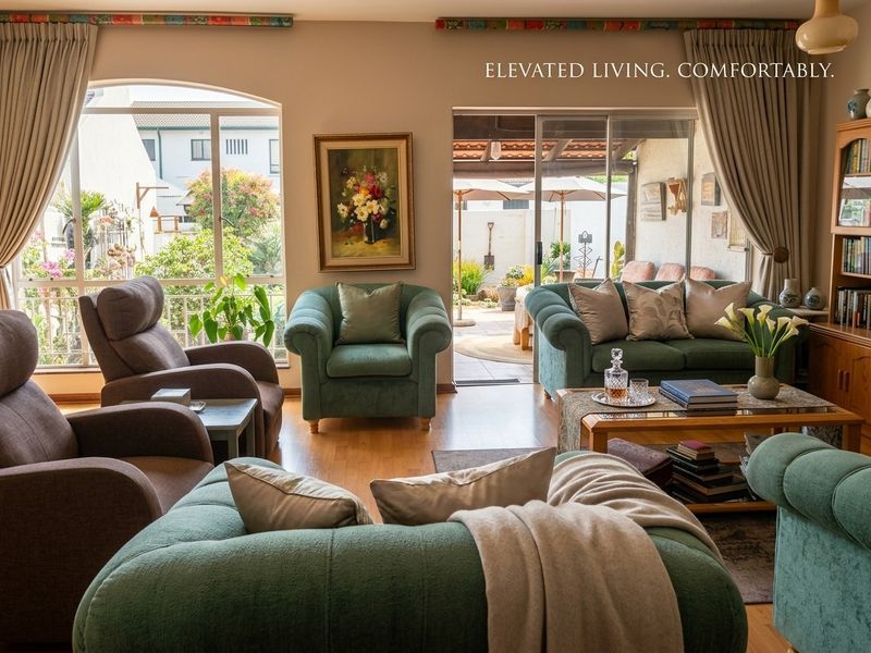 A comfortable living room featuring laminate flooring, large windows, and sliding glass doors that provide direct access to the outdoor patio area.