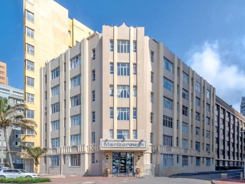 Exterior view of the Marlborough apartment building, showcasing its multi-story facade, architectural detailing, and street-level entrance.