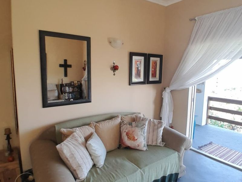 A living room area featuring a sliding glass door providing access to an outdoor balcony space.