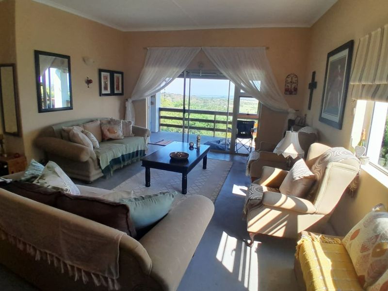 A comfortable living room featuring large sliding glass doors that provide natural light and direct access to an outdoor balcony with scenic views.