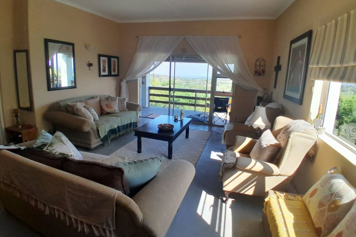 A comfortable living room featuring large sliding glass doors that provide natural light and direct access to an outdoor balcony with scenic views.