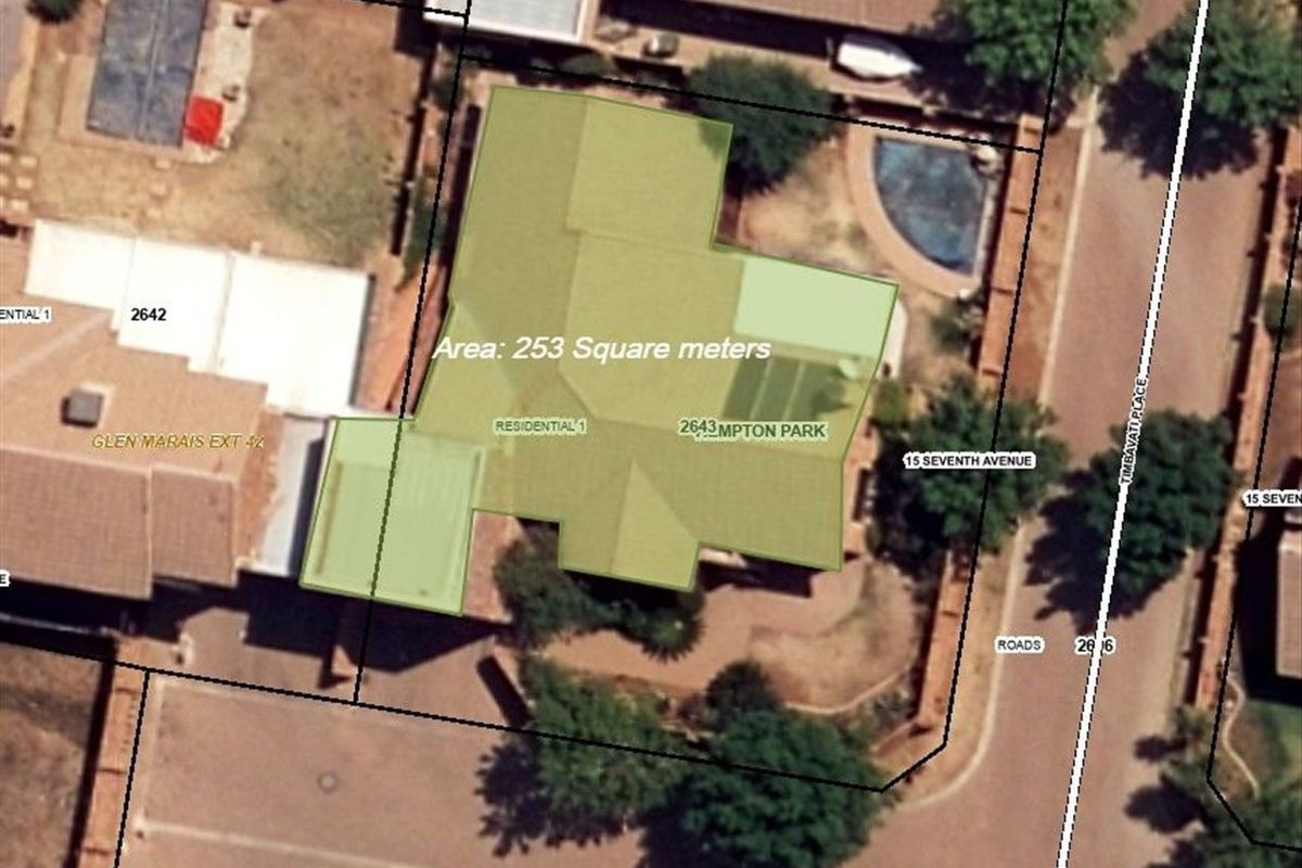 Aerial view of the property showing the roof layout, swimming pool, and surrounding site boundaries.