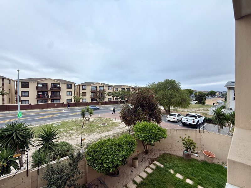 An elevated view overlooking the apartment complex grounds, surrounding neighborhood, and street frontage.