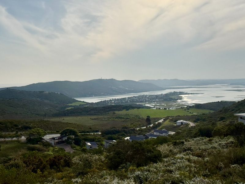 Elevated panoramic view overlooking the surrounding landscape, estuary, and distant hills, showcasing the natural beauty of the residential estate location.