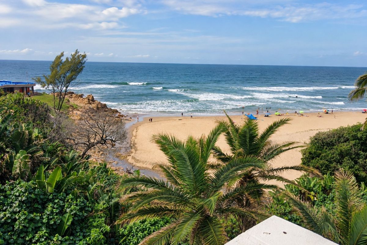 A scenic elevated view overlooking a sandy beach, ocean waves, and coastal vegetation.