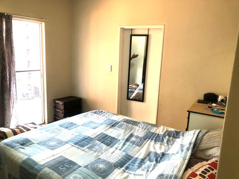 A bedroom featuring a sliding glass door providing access to an outdoor area and a standard interior door frame.