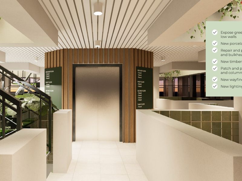 A modern commercial lobby featuring a central elevator with timber-look cladding, wayfinding signage, slatted ceilings, and clean porcelain floor tiles.