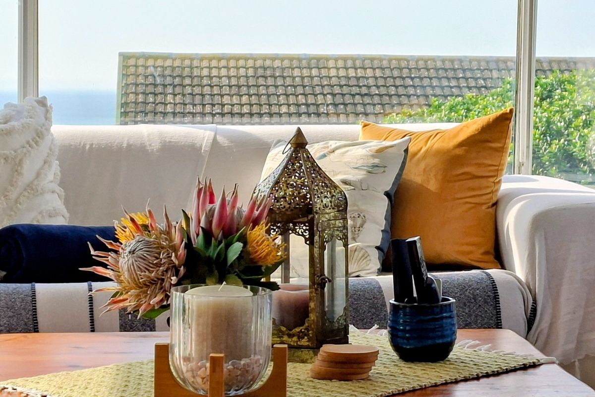 A cozy living area featuring large windows that provide natural light and a view of the outdoors.