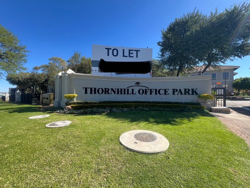 Entrance view of Thornhill Office Park featuring professional signage, manicured lawns, and secure gated access.