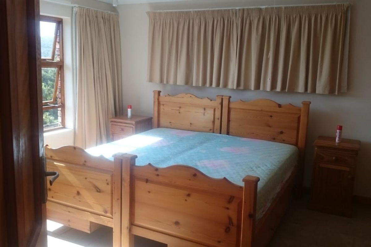 A standard bedroom featuring tiled flooring and a window with natural light, offering a functional space ready for modern updates.