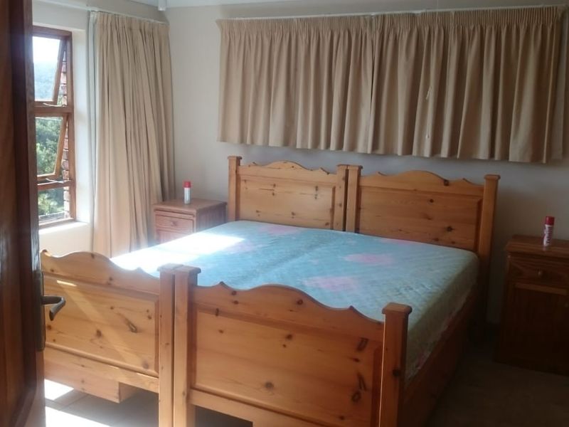 A standard bedroom featuring tiled flooring and a window with natural light, offering a functional space ready for modern updates.