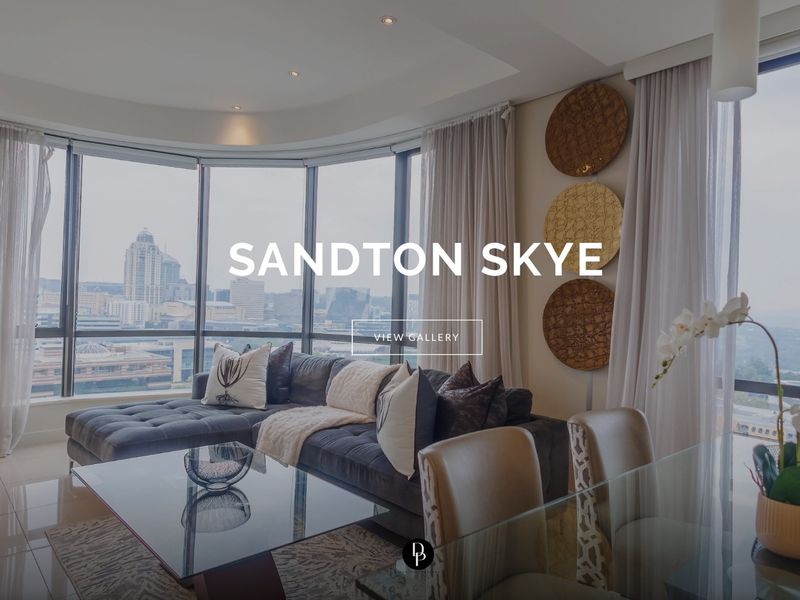 Modern living area featuring expansive floor-to-ceiling windows with panoramic city views, recessed lighting, and sleek tiled flooring.