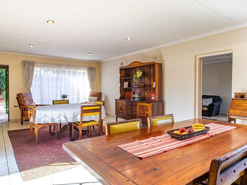Spacious dining area featuring tiled flooring, recessed downlighting, and direct access to the outdoor patio area.