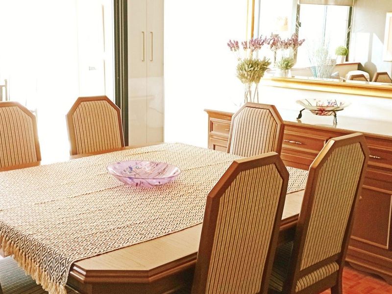 A dining room area featuring traditional parquet flooring and access to an adjacent outdoor space.