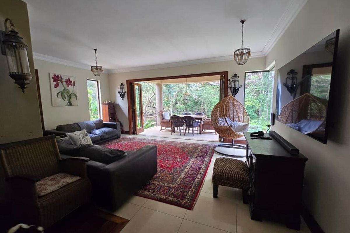 Spacious living room featuring large bi-fold doors that open onto a covered patio, creating a seamless indoor-outdoor flow.