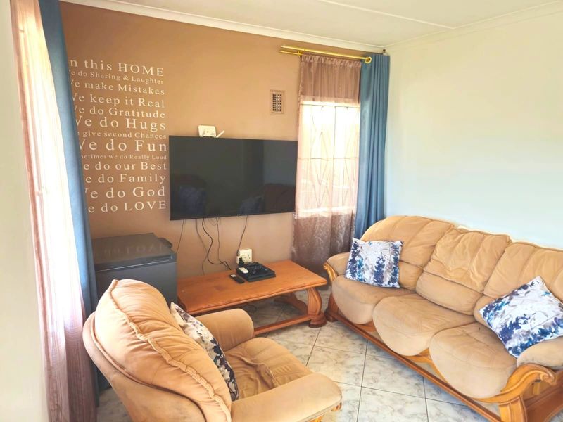 A living room featuring tiled flooring and neutral wall finishes, providing a functional space for relaxation.