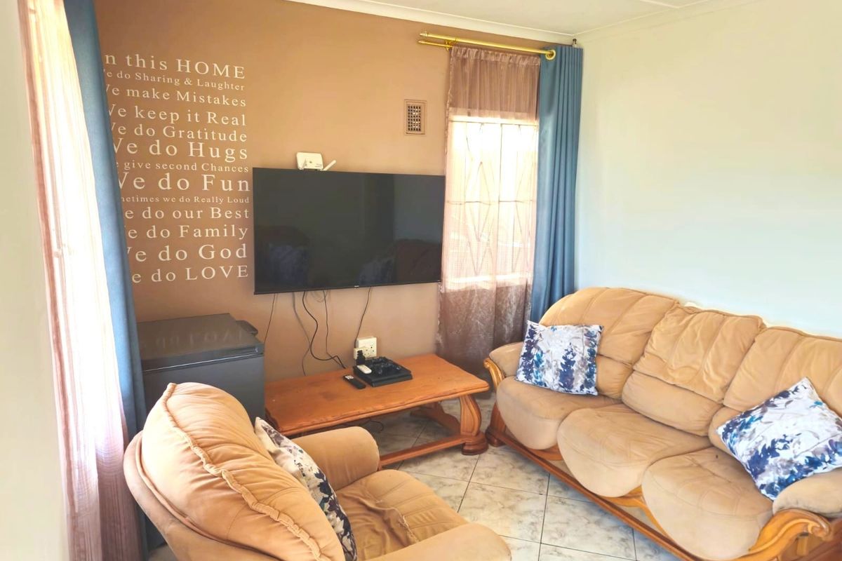 A living room featuring tiled flooring and neutral wall finishes, providing a functional space for relaxation.