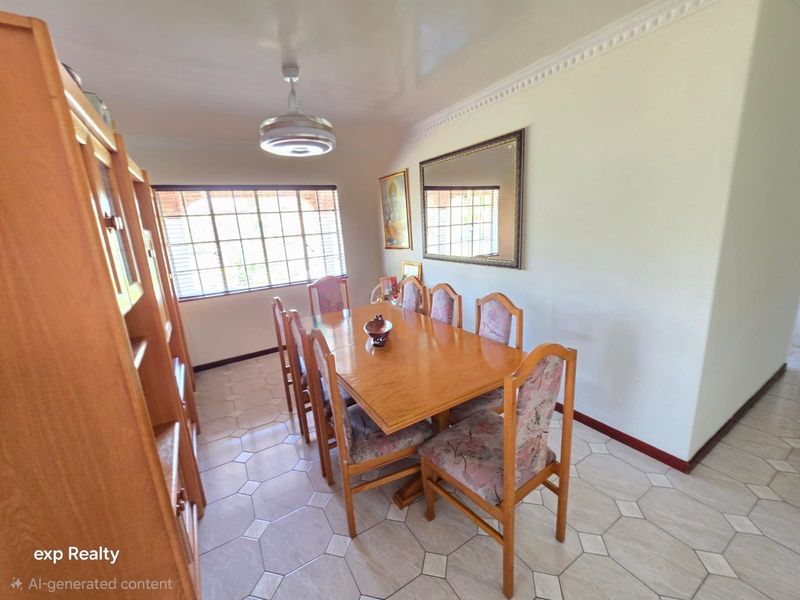 A dining room featuring tiled flooring, decorative ceiling cornice, and a grid-pattern window, providing a functional space for family meals.