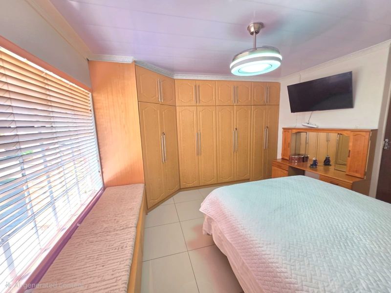 A bedroom featuring extensive built-in wooden cabinetry, a window seat, tiled flooring, and a modern ceiling fan with integrated lighting.