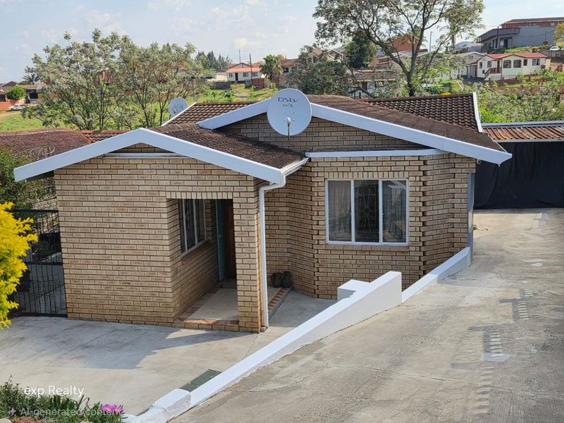 A well-maintained face brick house featuring a tiled roof, concrete driveway, and secure window bars, situated in a residential neighborhood.
