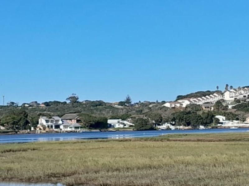 A scenic view of the estuary and surrounding residential landscape, showcasing the natural waterfront setting of the property.