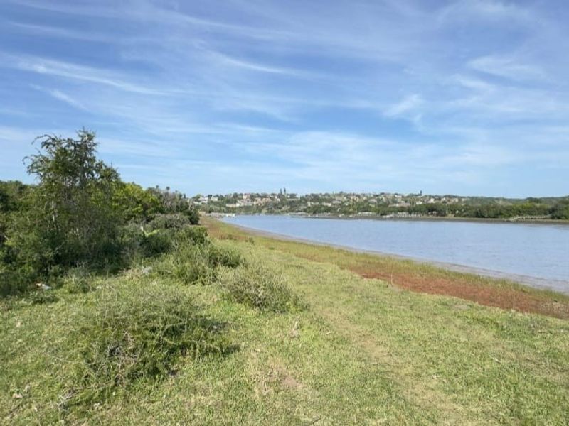 A scenic view of the riverfront landscape, showcasing the natural terrain and surrounding greenery.