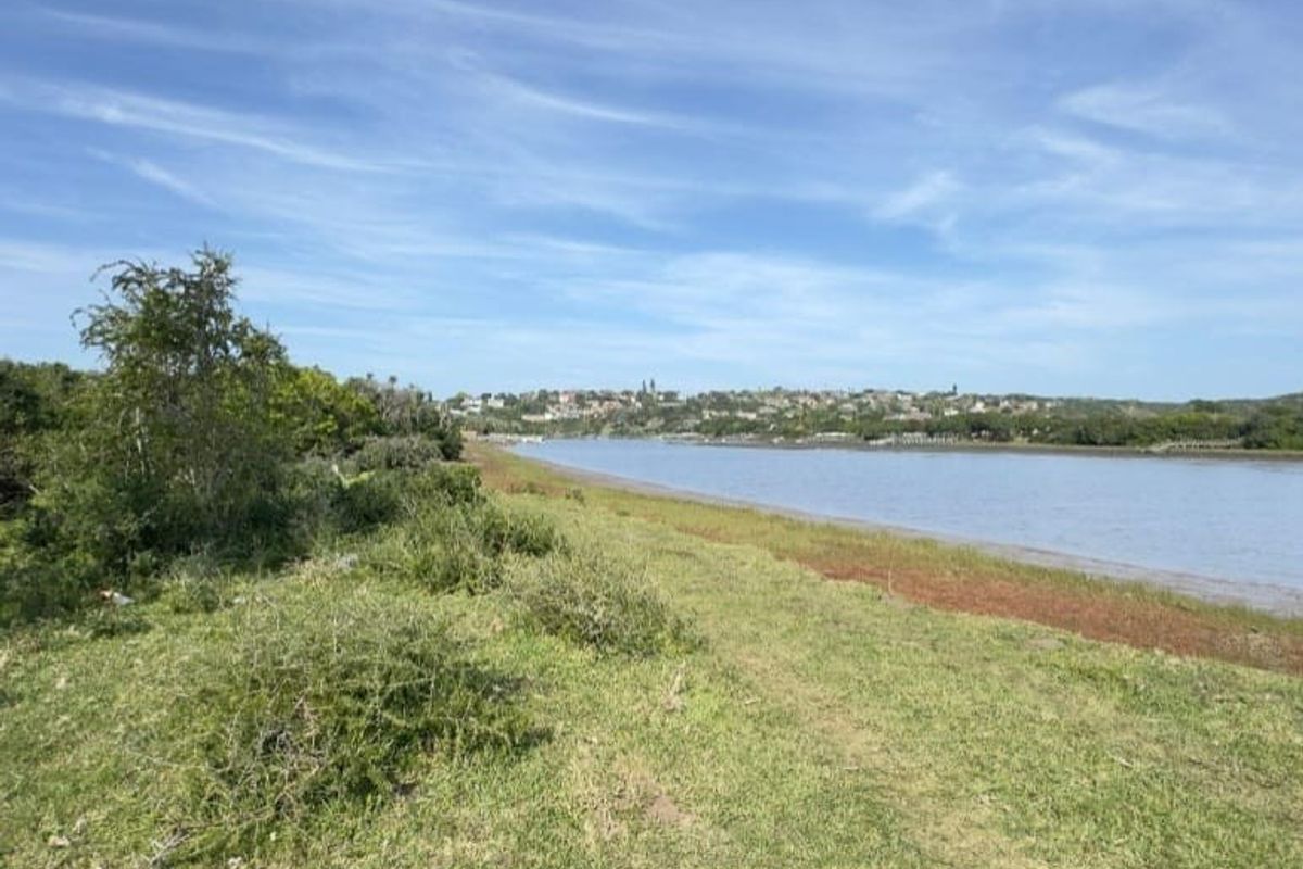 A scenic view of the riverfront landscape, showcasing the natural terrain and surrounding greenery.