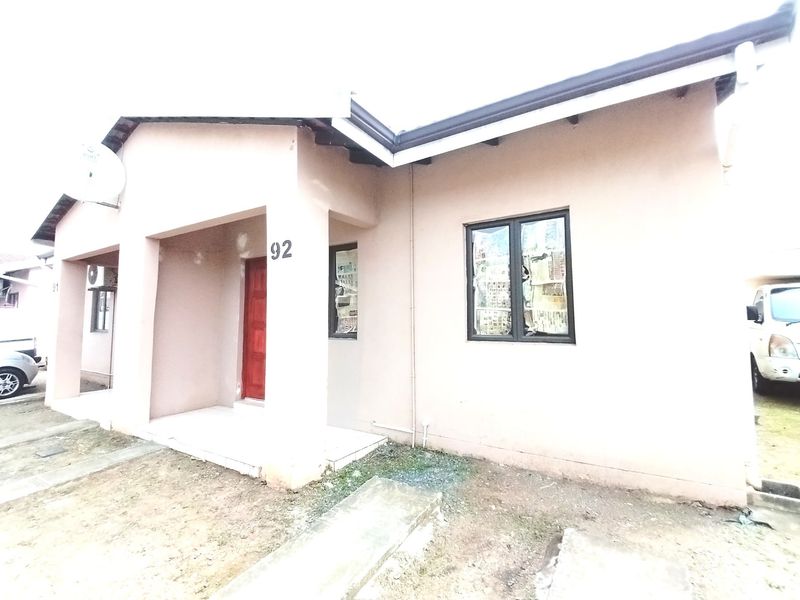 Front elevation of a single-story residential house featuring a covered entrance porch, aluminium window frames, and a tiled roof.