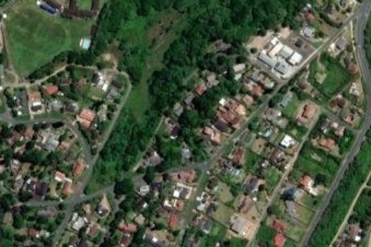 An aerial satellite view showing the property location within the surrounding residential neighborhood and coastal area.