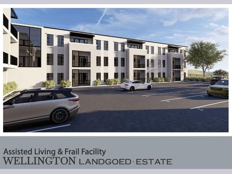 A digital architectural rendering of the Wellington Landgoed Estate assisted living and frail care facility, featuring a modern multi-story building and paved parking area.