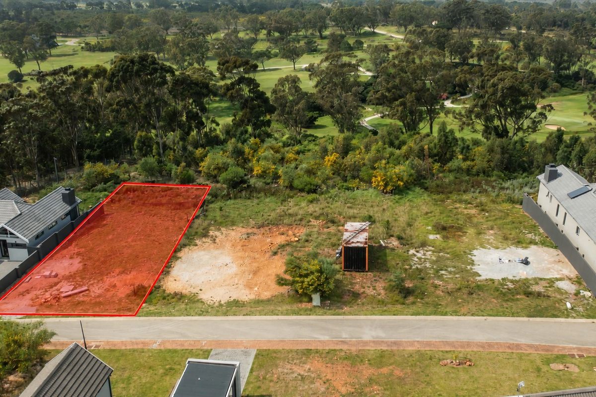 Aerial view of a vacant residential plot situated in a golf estate, highlighting the undeveloped land and surrounding landscape.