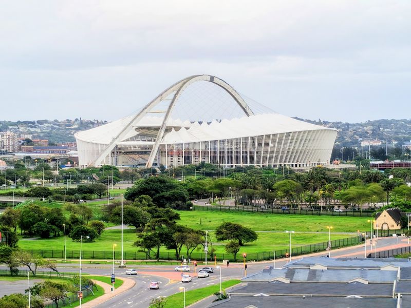 An elevated panoramic view overlooking the surrounding urban landscape and the prominent stadium structure in the distance.