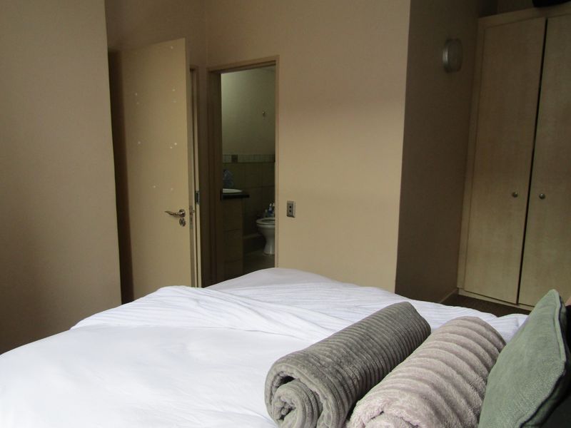 A bedroom featuring a built-in wardrobe and direct access to an en-suite bathroom.
