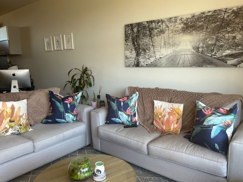 A comfortable living room space featuring neutral wall tones and ample room for seating arrangements.