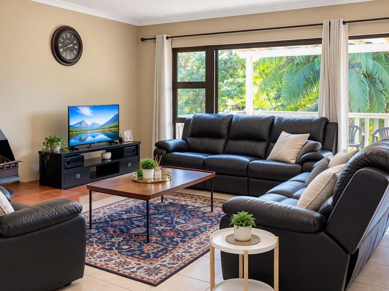A comfortable living room featuring a modern freestanding fireplace, neutral tiled flooring, and large sliding glass doors that provide access to an outdoor patio area.