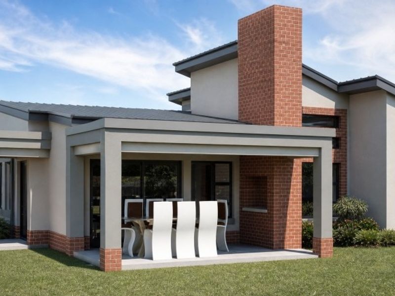 A modern covered patio featuring a built-in brick fireplace and chimney, providing a seamless transition to the garden area.