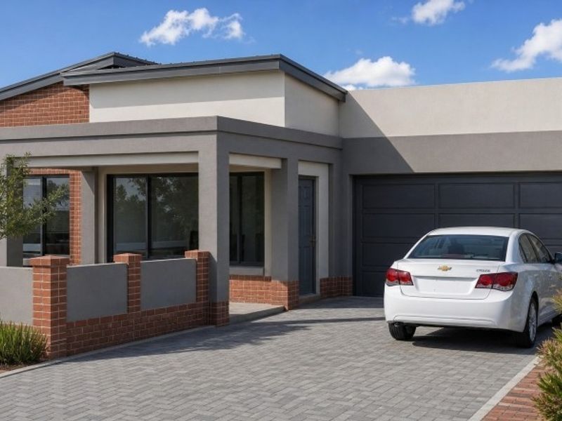 Modern single-story residential home featuring a combination of brick and rendered masonry finishes, a paved driveway, and an integrated garage.