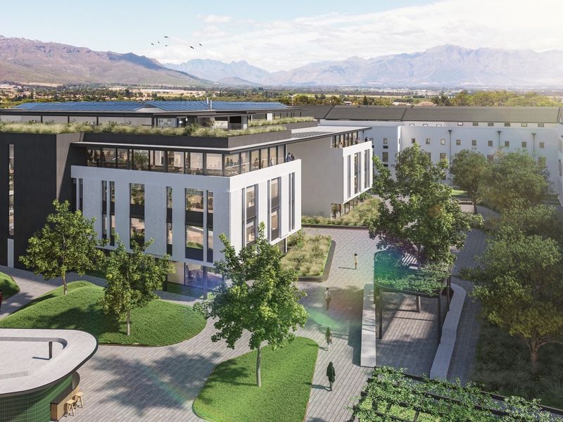 Aerial view of a modern office complex featuring landscaped courtyards, paved walkways, green roof elements, and solar panel installations.