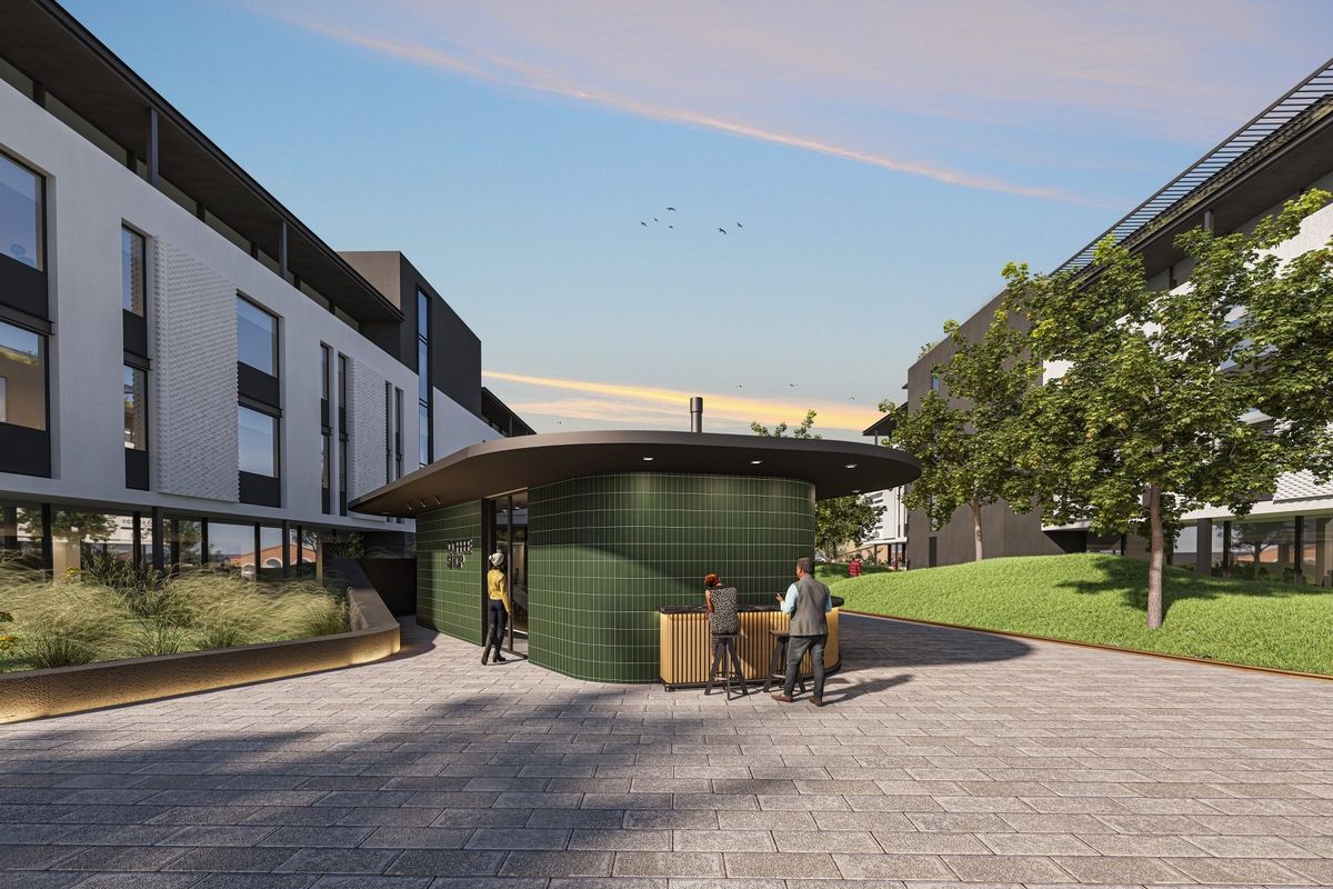 A modern office courtyard featuring a green tiled kiosk, paved walkways, and landscaped green spaces between contemporary office buildings.