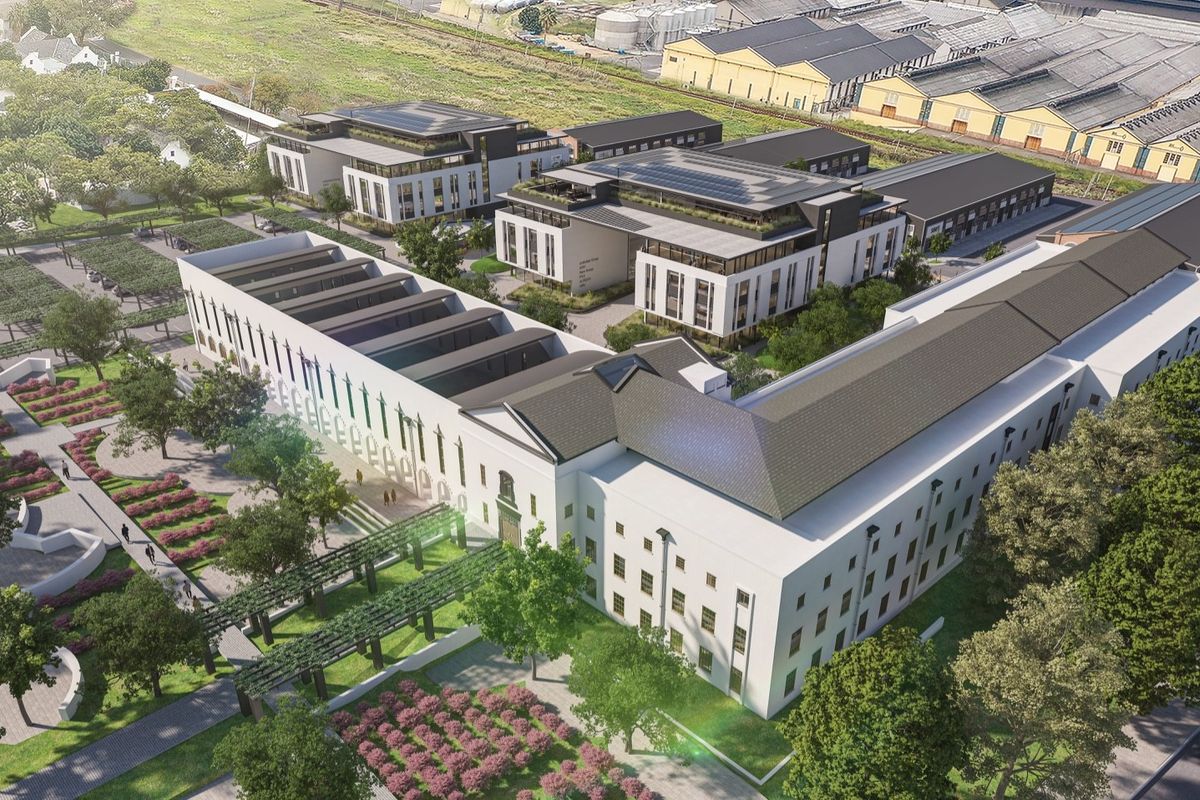 Aerial view of a modern office complex featuring multiple buildings, landscaped gardens, paved walkways, and dedicated parking areas.