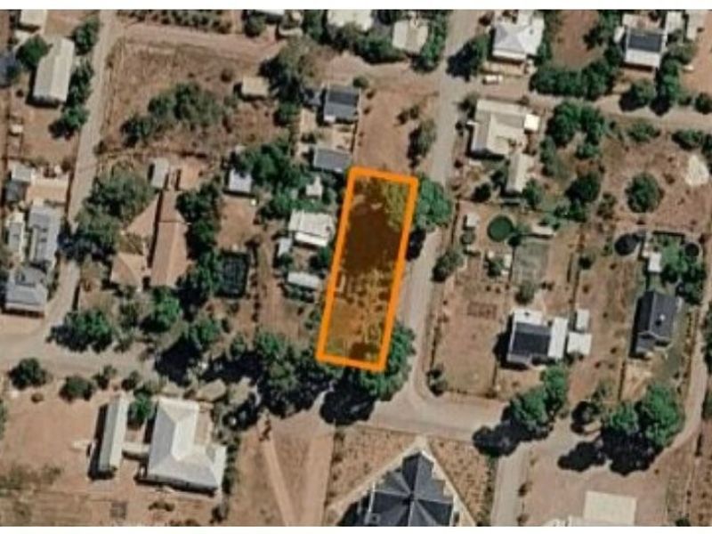An aerial view showing the residential vacant land plot highlighted in orange within the surrounding neighborhood context.