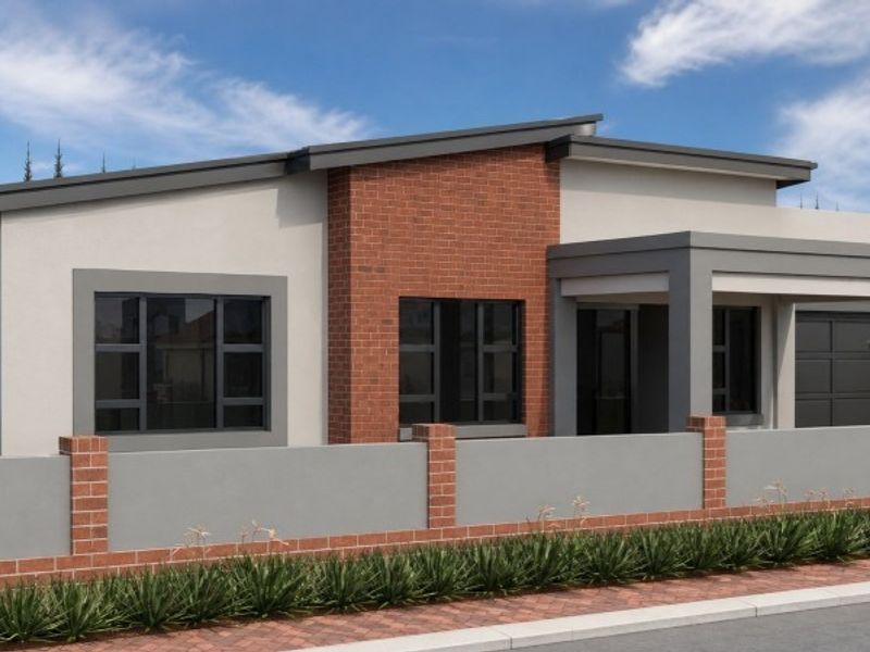 Modern single-story house exterior featuring a combination of brick and plastered finishes, a secure boundary wall, and a paved driveway.
