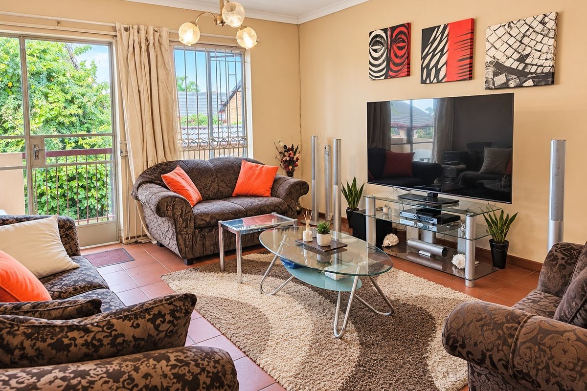 A comfortable living room featuring tiled flooring and a sliding glass door that provides access to an outdoor area.