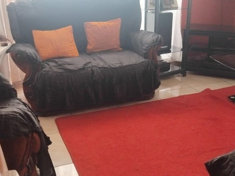 A living room area featuring tiled flooring, providing a functional space for relaxation and entertainment.