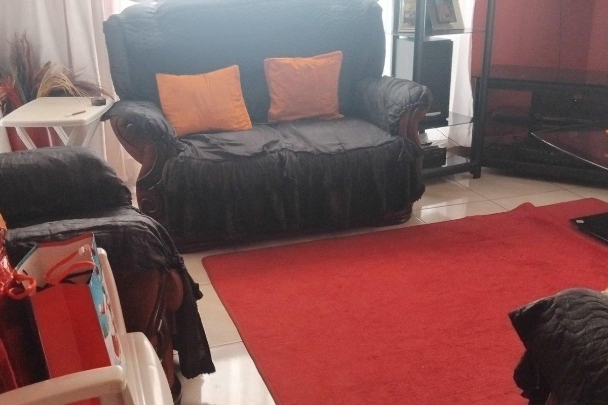A living room area featuring tiled flooring, providing a functional space for relaxation and entertainment.